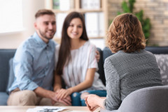 Psychologist working with married couple in office